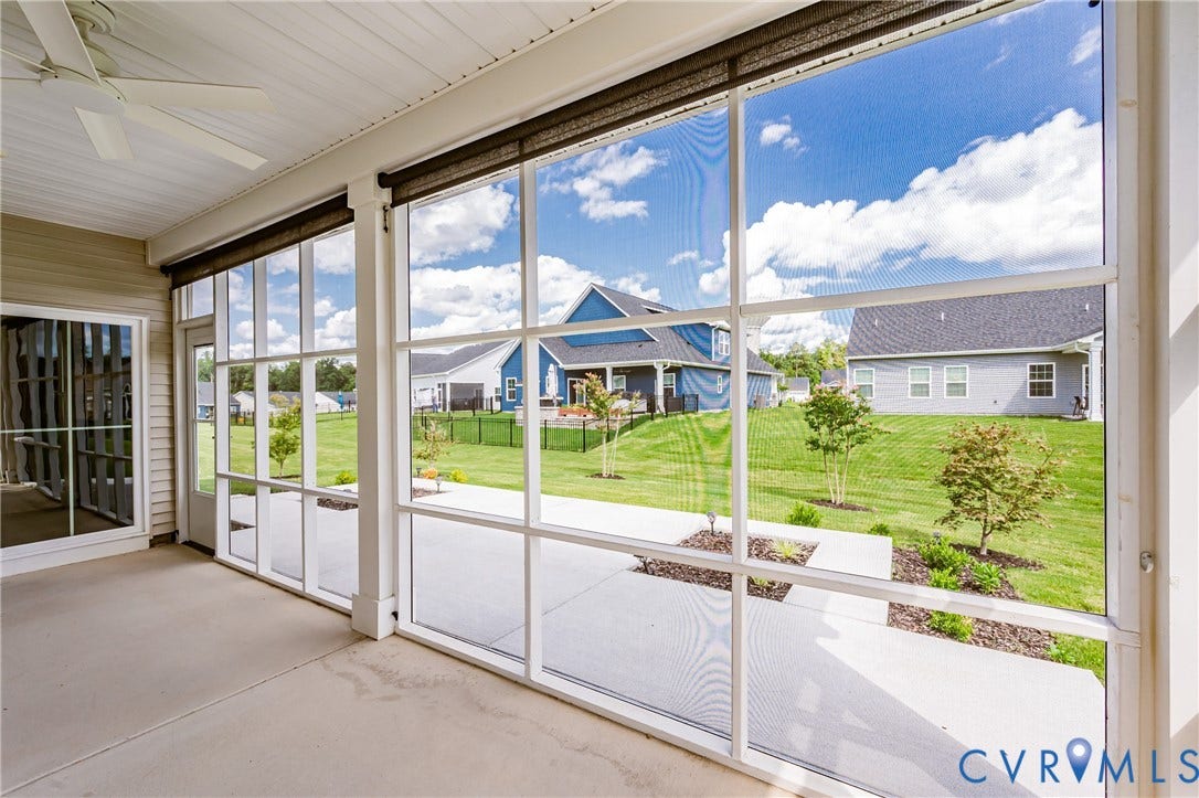 7683 Autumn Leaves Lane, Estates The Groves At New Kent, New Kent, VA 23124 Screened porch with concrete flooring, white ceiling fan, and sliding glass door