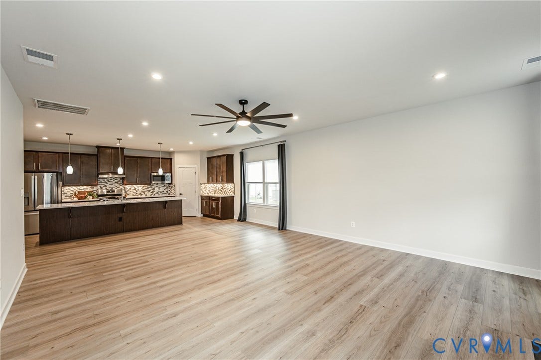 7683 Autumn Leaves Lane, Estates The Groves At New Kent, New Kent, VA 23124 Open-concept living area featuring wood-finish flooring, recessed lighting, and a ceiling fan