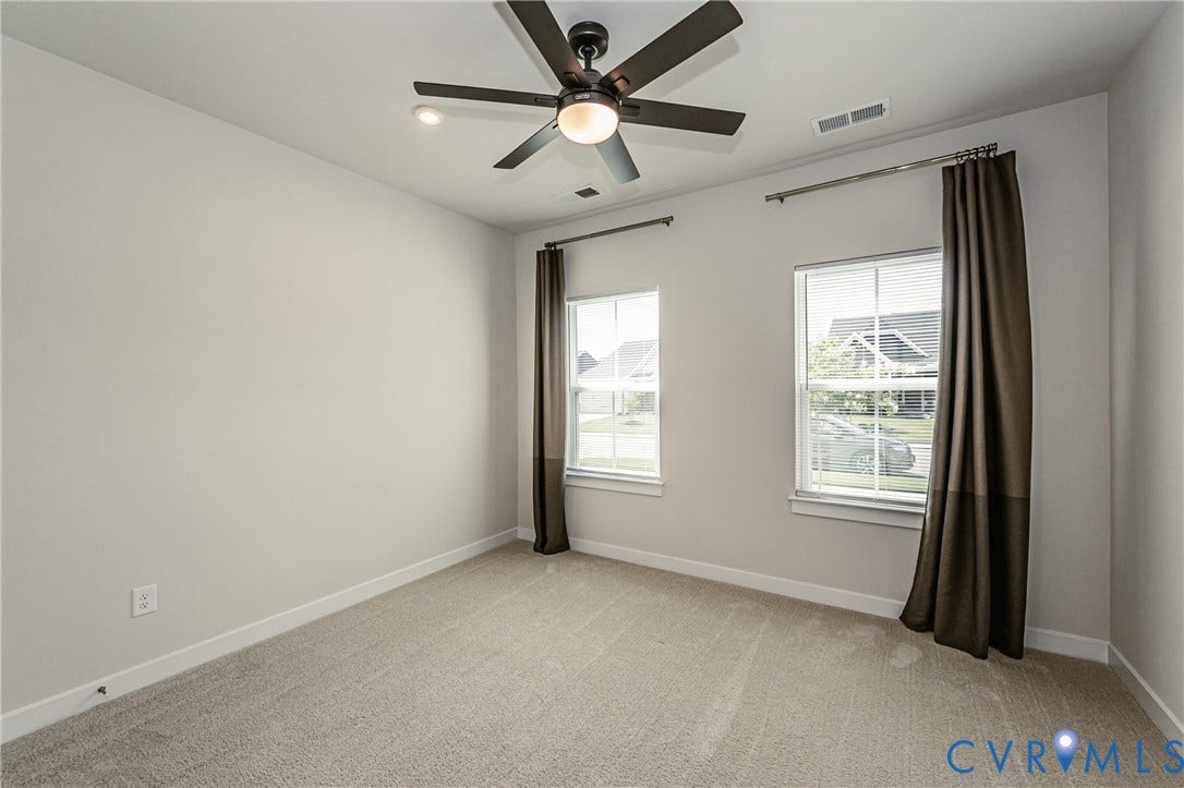 7683 Autumn Leaves Lane, Estates The Groves At New Kent, New Kent, VA 23124 Neutral wall color, wall-to-wall carpeting, two windows, recessed lighting, and a ceiling fan with integrated lighting
