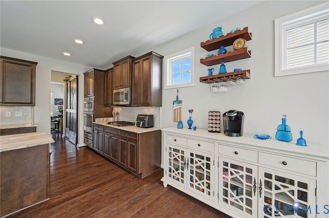 Hardwood-finish flooring, recessed lighting, wood cabinetry, built-in stainless steel appliances, and a tile backsplash