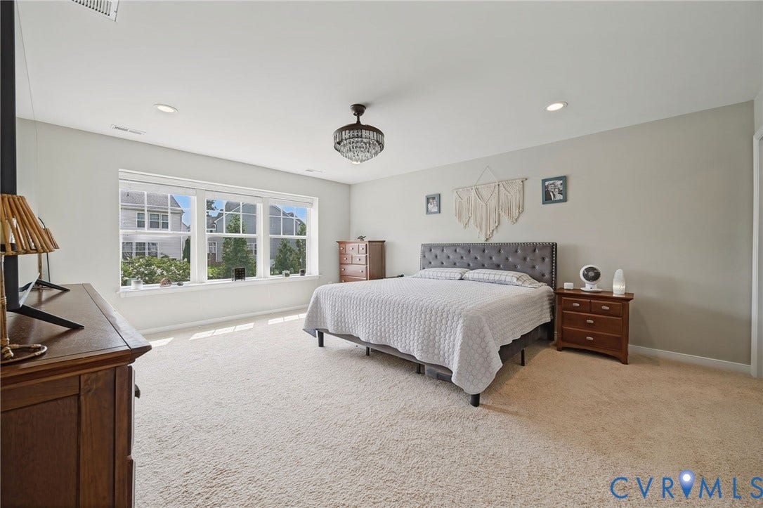 Recessed lighting, broad window, and a chandelier fixture