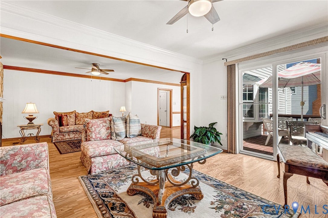 Bright large sun room with laminate flooring and open to deck
