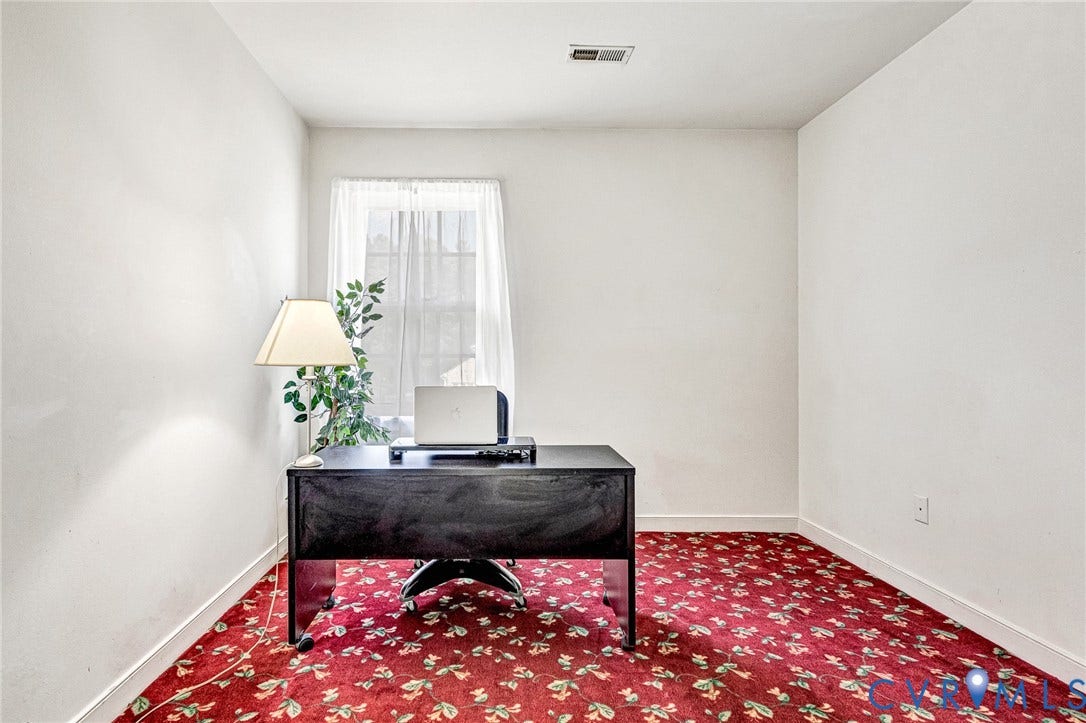 Bright interior room with white walls and a window