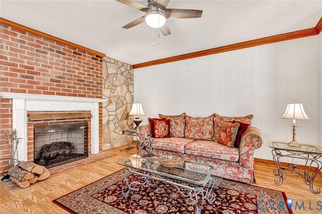 Hardwood flooring throughout, crown molding, and a ceiling fan with integrated lighting