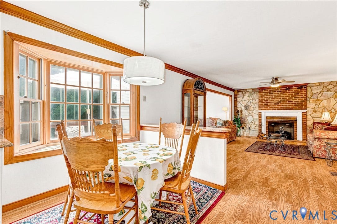 Wood-finish flooring throughout, complemented by white vertical paneling and crown molding
