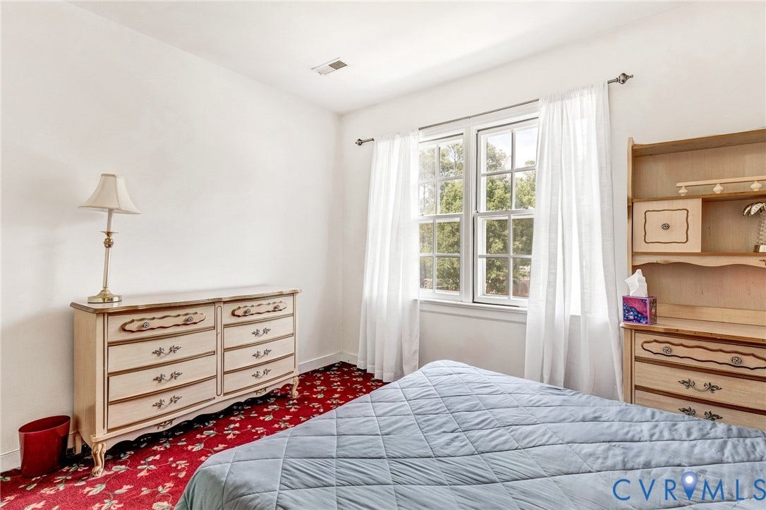 White walls and red patterned carpeting