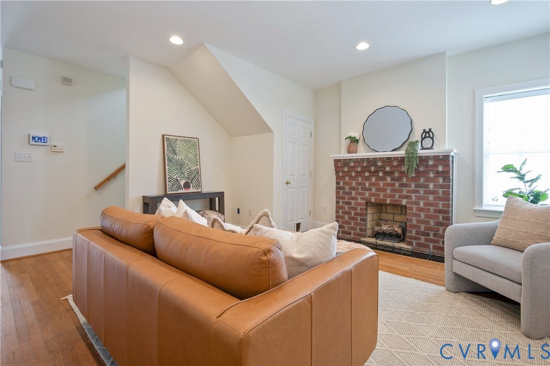 518 N 1st Street, Jackson Ward, Richmond, VA 23219 Living area featuring a brick fireplace, white mantel, recessed lighting, wood-finish flooring, and a stairway with wood railing