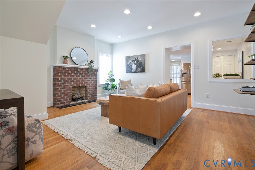 518 N 1st Street, Jackson Ward, Richmond, VA 23219 Brick fireplace with a white mantel, wood-finish flooring, recessed lighting, and a pass-through window