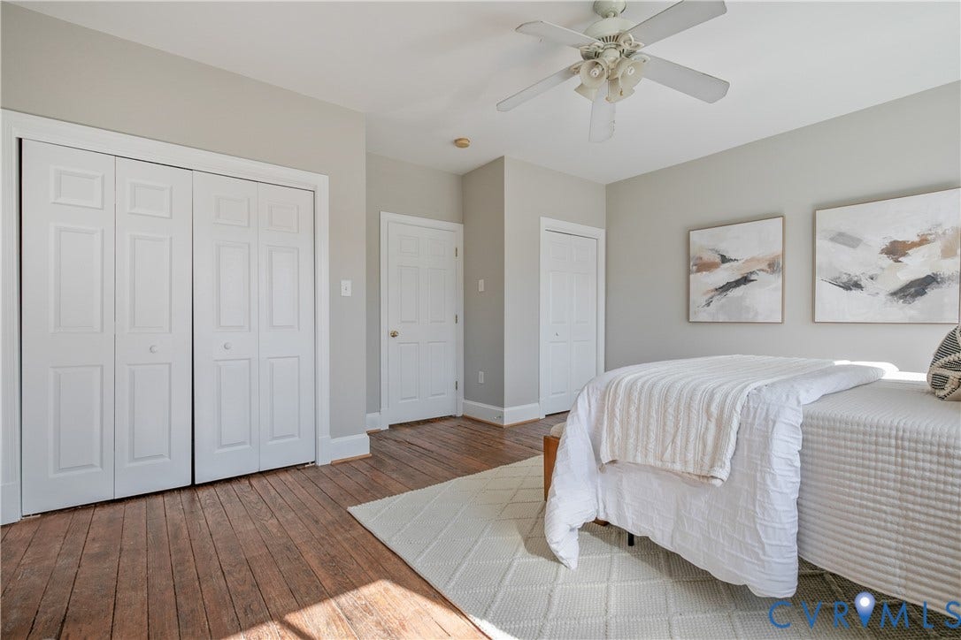 518 N 1st Street, Jackson Ward, Richmond, VA 23219 Wood-finish flooring, ceiling fan with light fixture, and white bi-fold closet doors