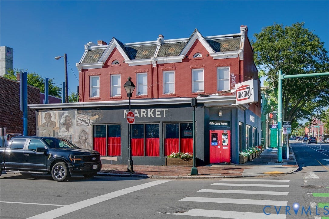518 N 1st Street, Jackson Ward, Richmond, VA 23219 Brick facade with multiple windows, street-level commercial space, and a red entry door