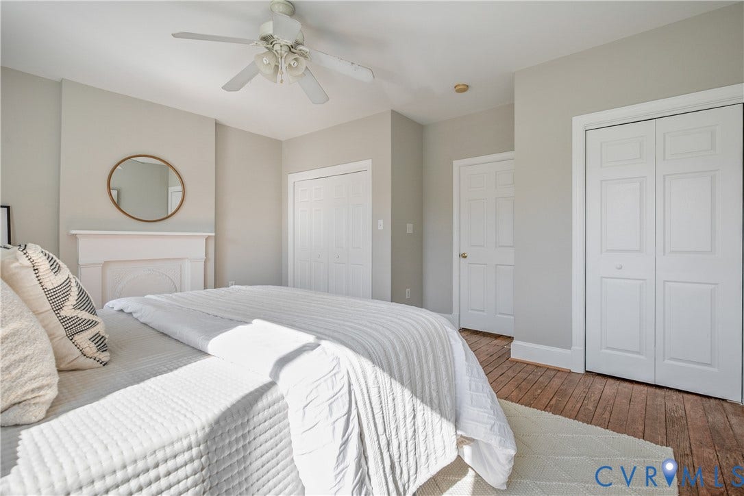 518 N 1st Street, Jackson Ward, Richmond, VA 23219 Hardwood flooring, ceiling fan, white paneled doors, and a decorative fireplace