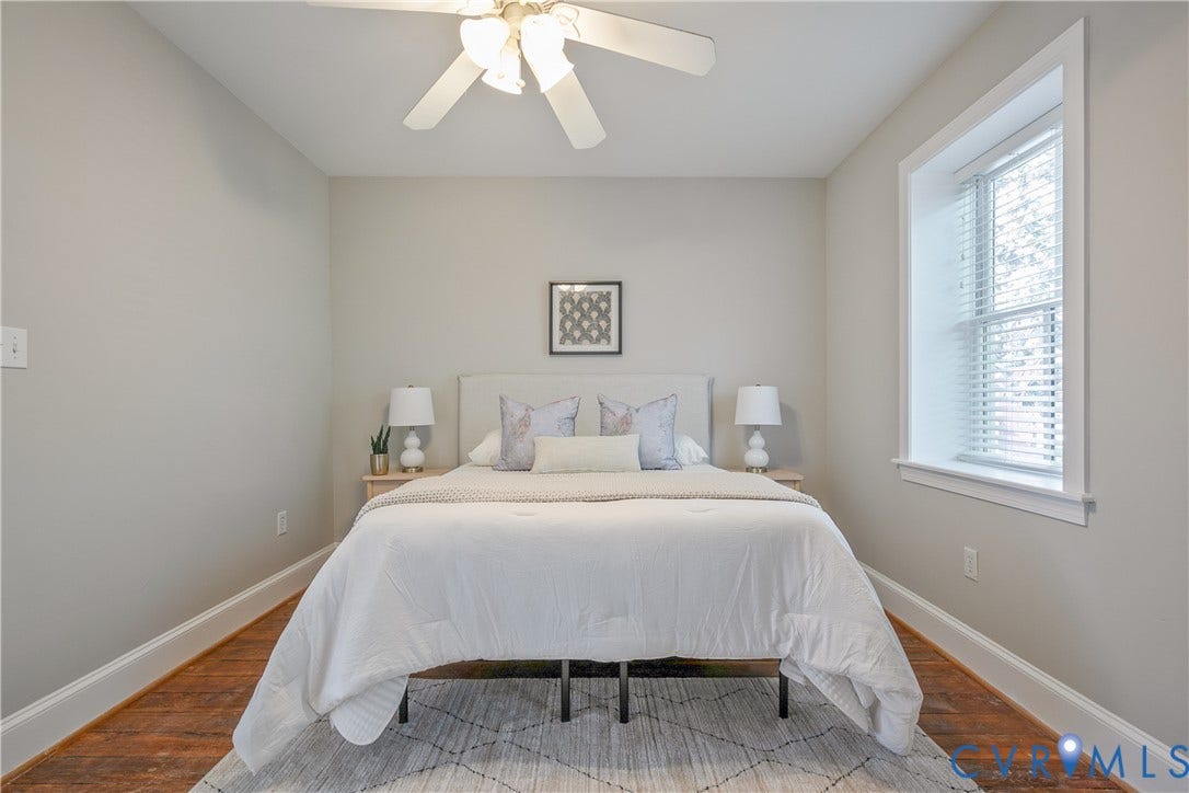 518 N 1st Street, Jackson Ward, Richmond, VA 23219 Serene primary bedroom featuring hardwood flooring, soft neutral wall finishes, and abundant natural light from a large picture window