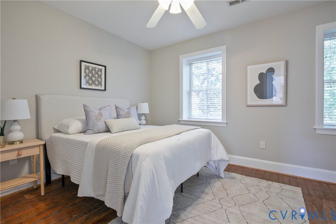 518 N 1st Street, Jackson Ward, Richmond, VA 23219 Hardwood flooring, two windows with blinds, ceiling fan, neutral wall paint, and white trim