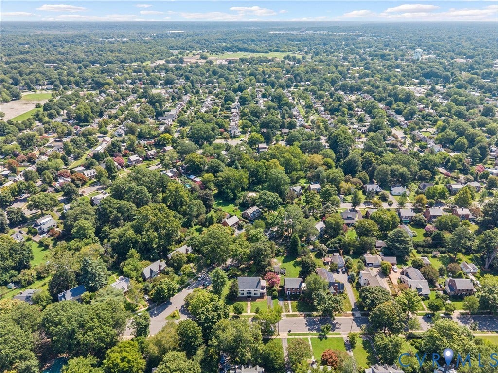 Aerial view of an established residential neighborhood featuring tree-lined streets, mature landscaping throughout the community, and single-family homes nestled among abundant greenery