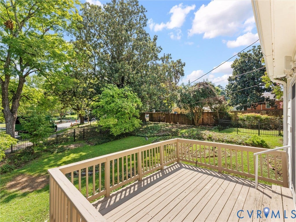 Expansive outdoor deck with wood-finish flooring and railing