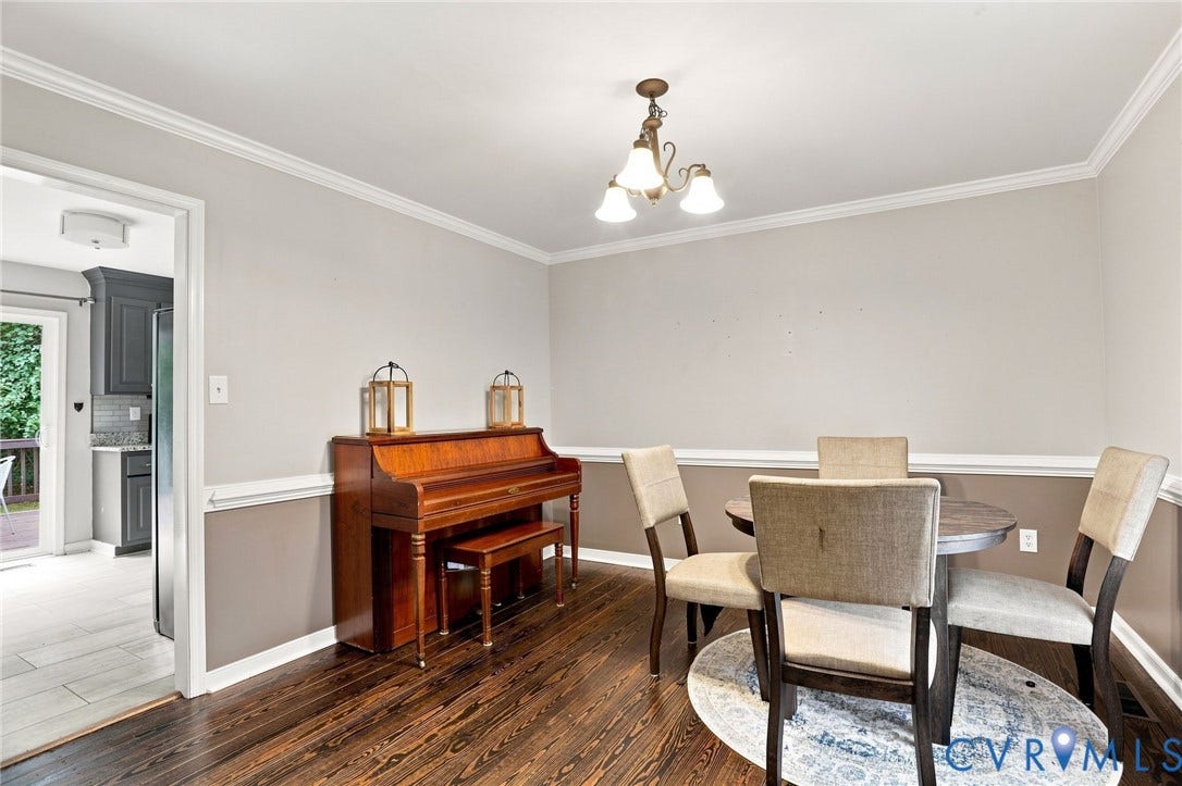 Dark wood-finish flooring with white crown molding