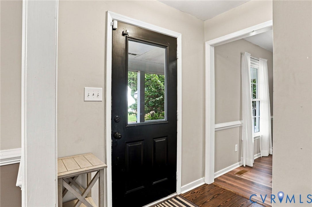 Black paneled door with clear glass insert