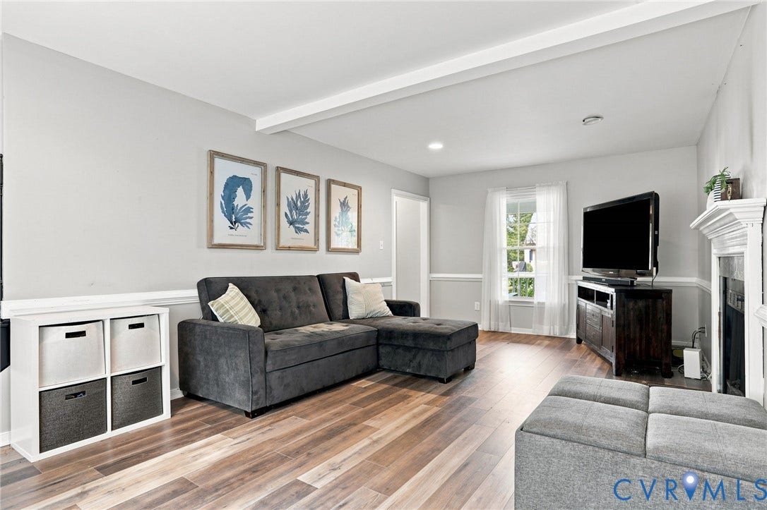 Wood-finish flooring throughout, white trim, recessed lighting, and a window for natural illumination