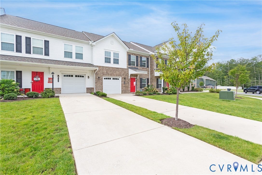 11419 Dunmore Mill Court, Chester, VA 23831 Townhome exterior featuring white siding, brick accents, black shutters, and red entry doors