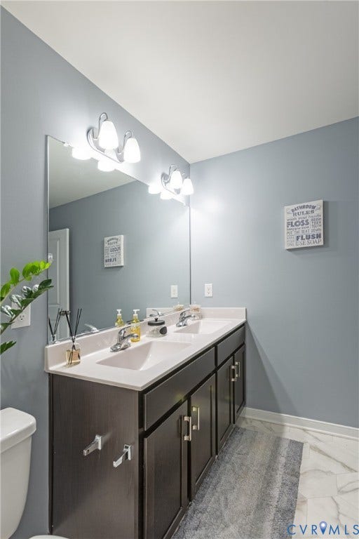 11419 Dunmore Mill Court, Chester, VA 23831 Dual vanity with white countertop, chrome fixtures, and a large mirror