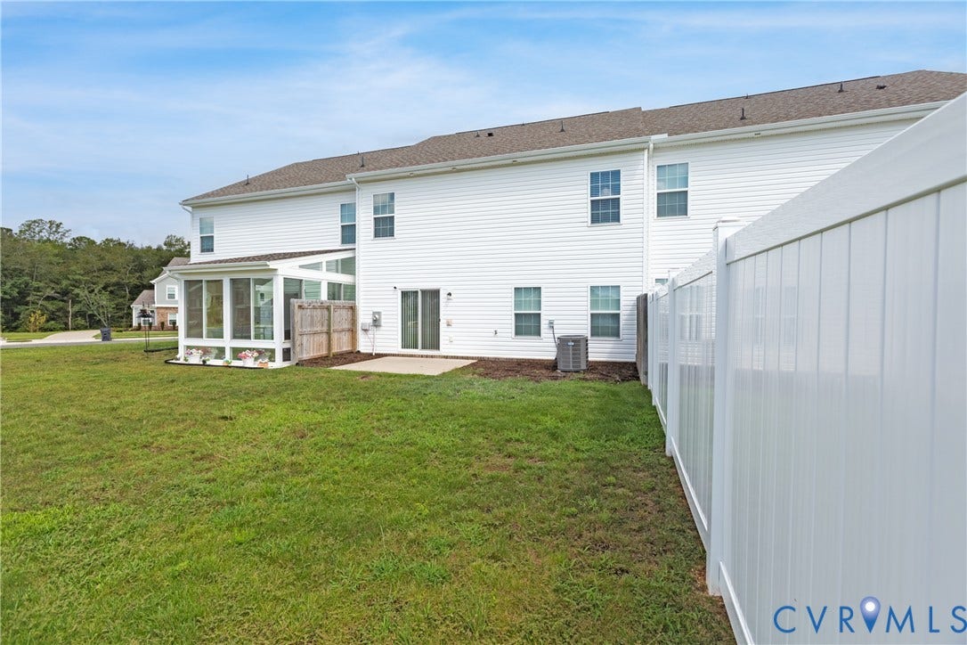 11419 Dunmore Mill Court, Chester, VA 23831 Expansive backyard featuring a screened porch, concrete patio, and white privacy fencing