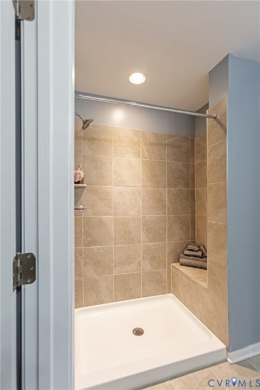 11419 Dunmore Mill Court, Chester, VA 23831 Shower enclosure featuring light-colored square wall tiles, a built-in shower bench, a chrome shower head, and recessed ceiling lighting
