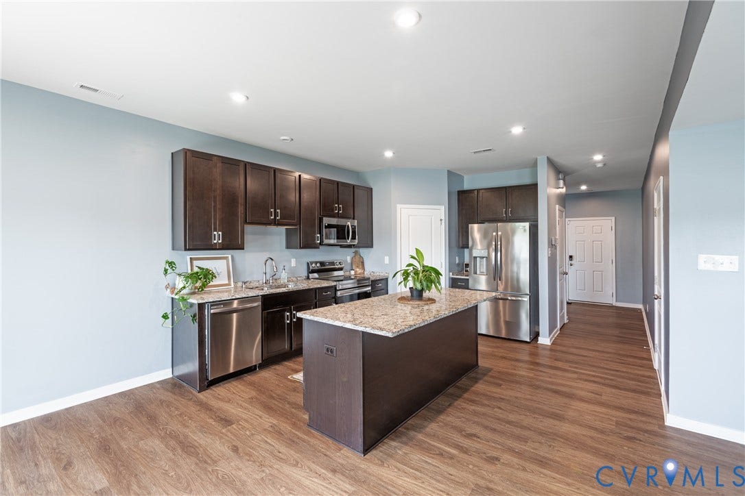11419 Dunmore Mill Court, Chester, VA 23831 Gourmet kitchen featuring dark wood cabinetry, stainless steel appliances, granite countertops, and a center island
