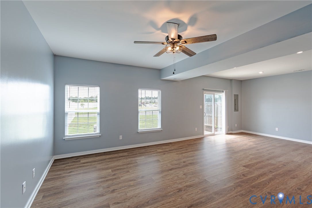 11419 Dunmore Mill Court, Chester, VA 23831 Wood-finish flooring, two windows with blinds, a ceiling fan with integrated lighting, recessed lighting, and a sliding glass door