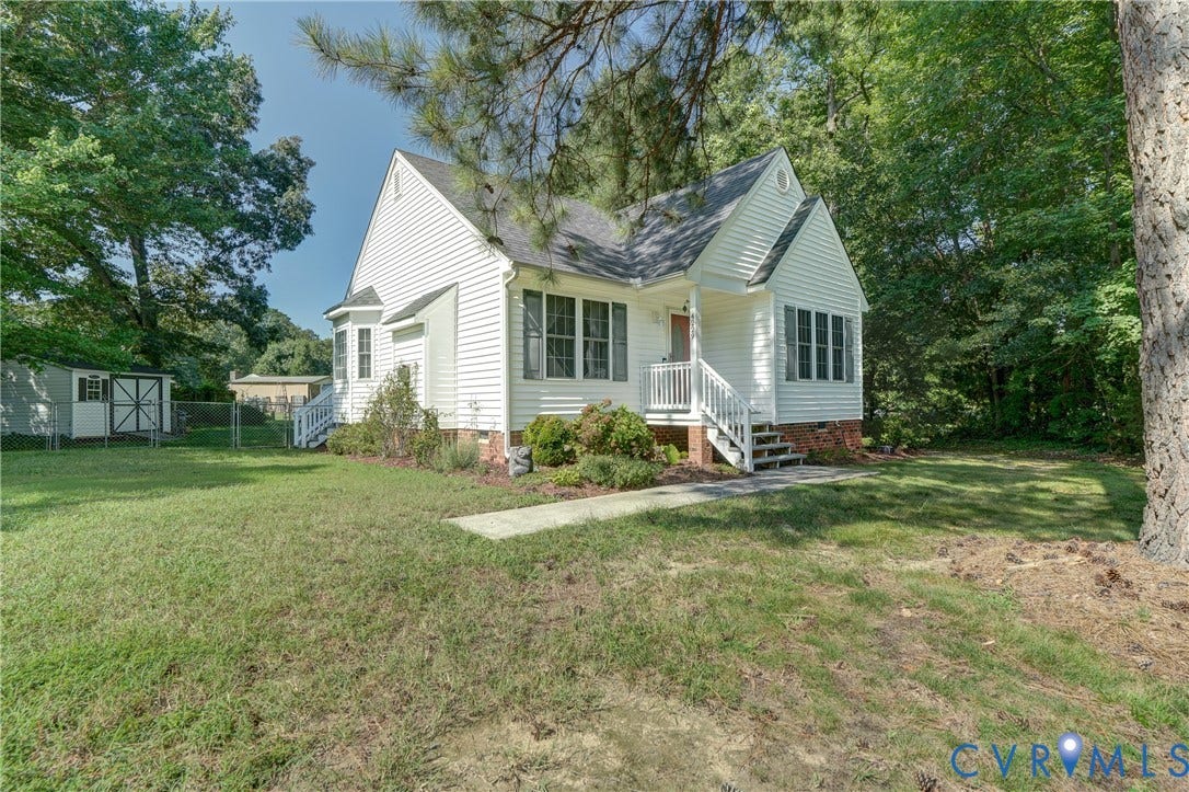 4229 Greenbriar Drive, Chester, VA 23831 White siding exterior, front porch with white railings, bay window, established perimeter trees, and a detached shed