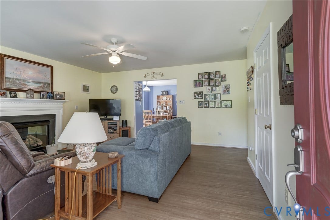 4229 Greenbriar Drive, Chester, VA 23831 Living area with a fireplace, a mantel, wood-finish flooring, and a ceiling fan
