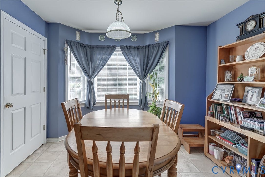 4229 Greenbriar Drive, Chester, VA 23831 Bay window with grid patterns, tiled flooring, built-in shelving, white paneled door, and overhead lighting fixture