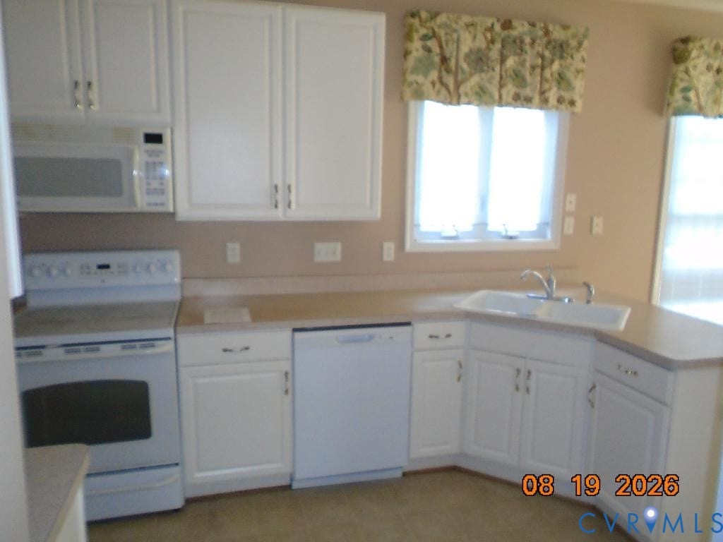 4113 Coles Point Way, Glen Allen, VA 23060 White cabinetry, built-in microwave, white electric range, white dishwasher, and corner sink