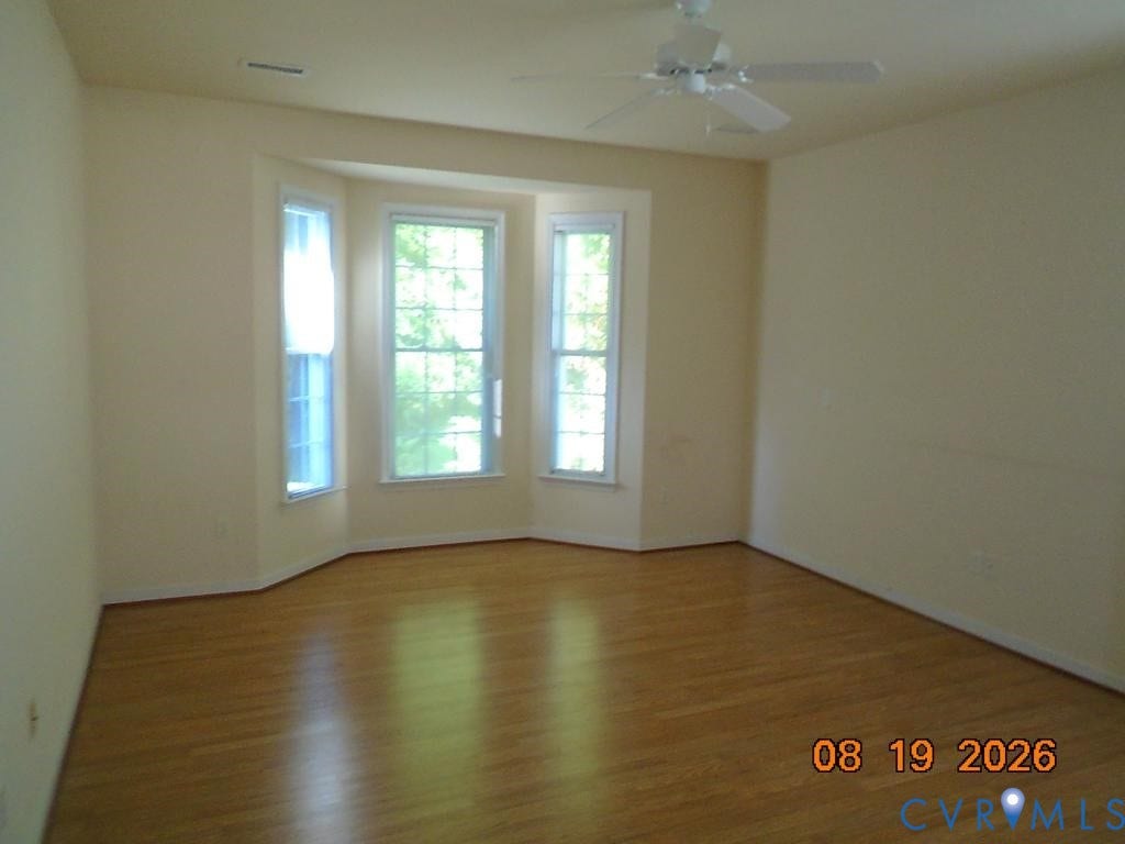 4113 Coles Point Way, Glen Allen, VA 23060 Bay window with three individual pane windows, wood-finish flooring, and a ceiling fan