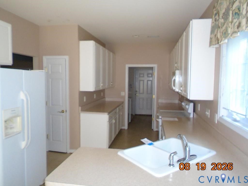 4113 Coles Point Way, Glen Allen, VA 23060 Kitchen with white cabinetry, light-toned countertops, and a double-basin sink