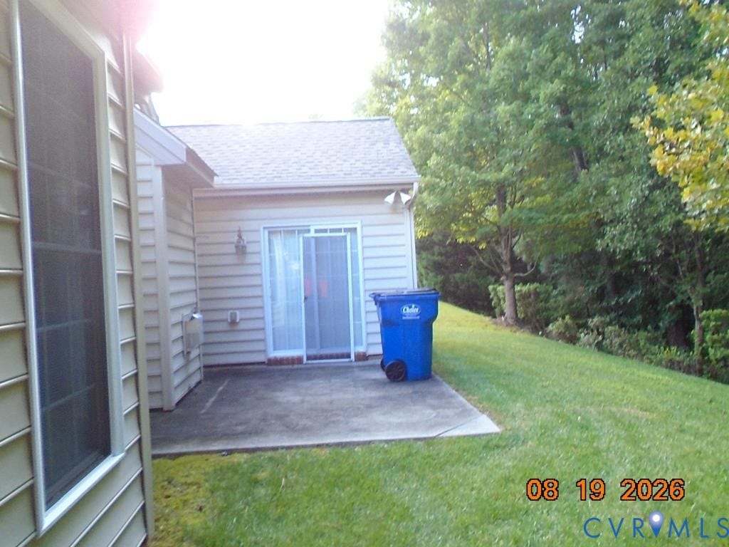 4113 Coles Point Way, Glen Allen, VA 23060 Patio area with concrete hardscaping, sliding glass door access, and a sloped lawn area
