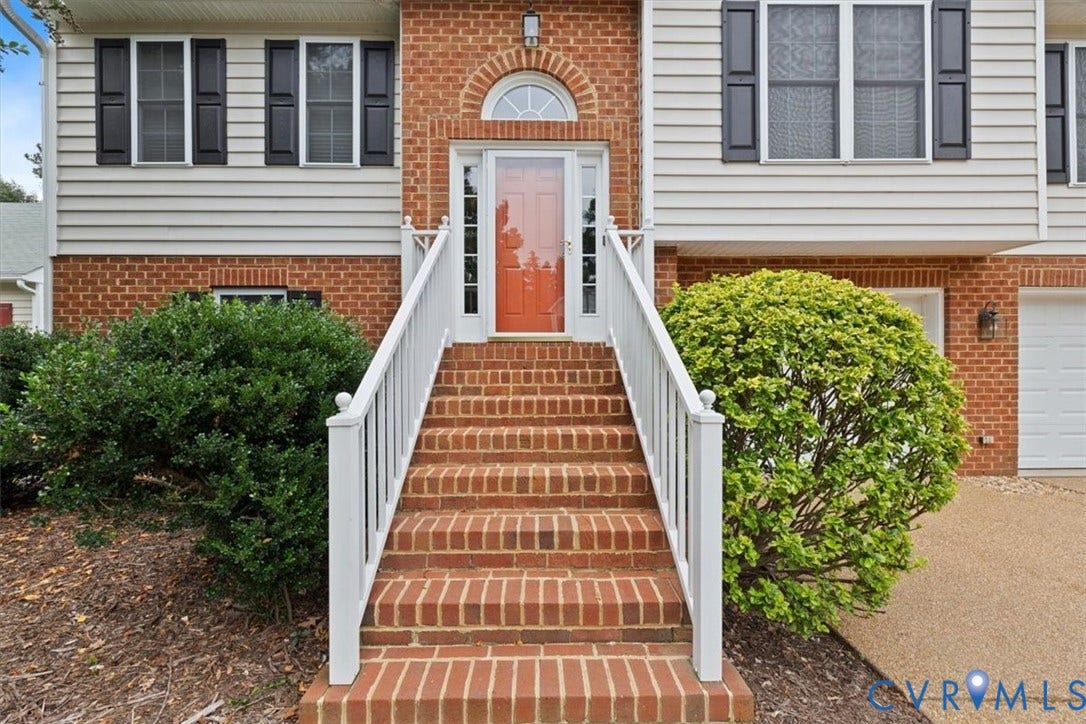 13819 Ashbourne Hollow Circle, Birkdale, Chesterfield, VA 23832 Two-story residence featuring a brick and vinyl siding exterior, two-car garage and an aggregate driveway