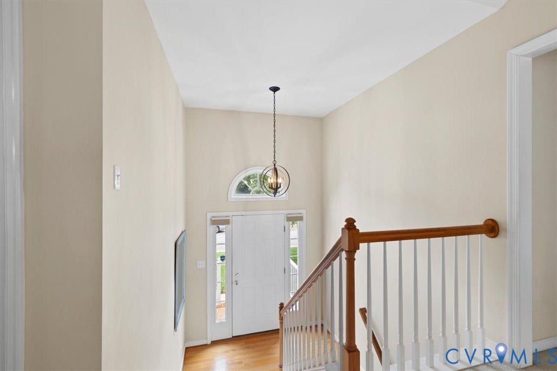 13819 Ashbourne Hollow Circle, Birkdale, Chesterfield, VA 23832 Grand foyer with high ceilings, arched transom window, hardwood flooring and a decorative pendant light fixture