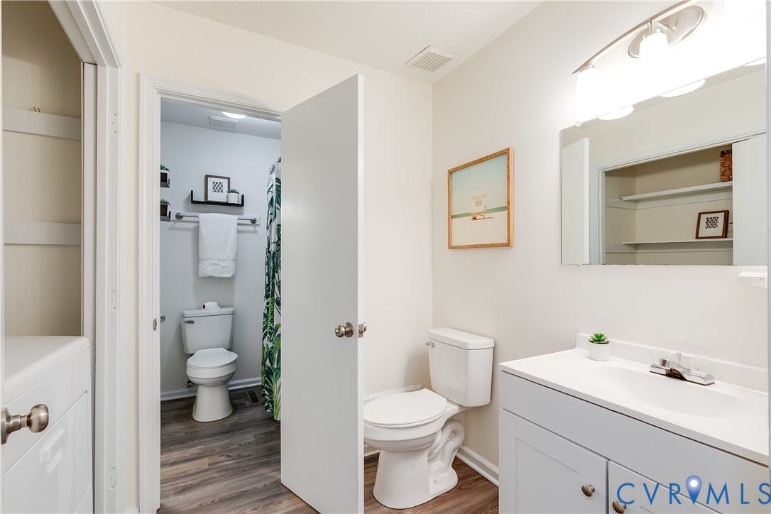 4116 Bronholly Road, Chesterfield, VA 23832 Bathroom featuring a single vanity with integrated sink, white cabinetry, and vinyl flooring