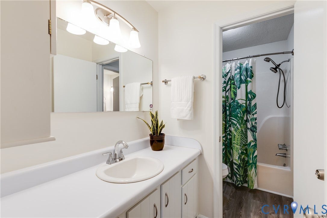 4116 Bronholly Road, Chesterfield, VA 23832 White vanity with integrated sink, chrome faucet, and cabinet storage