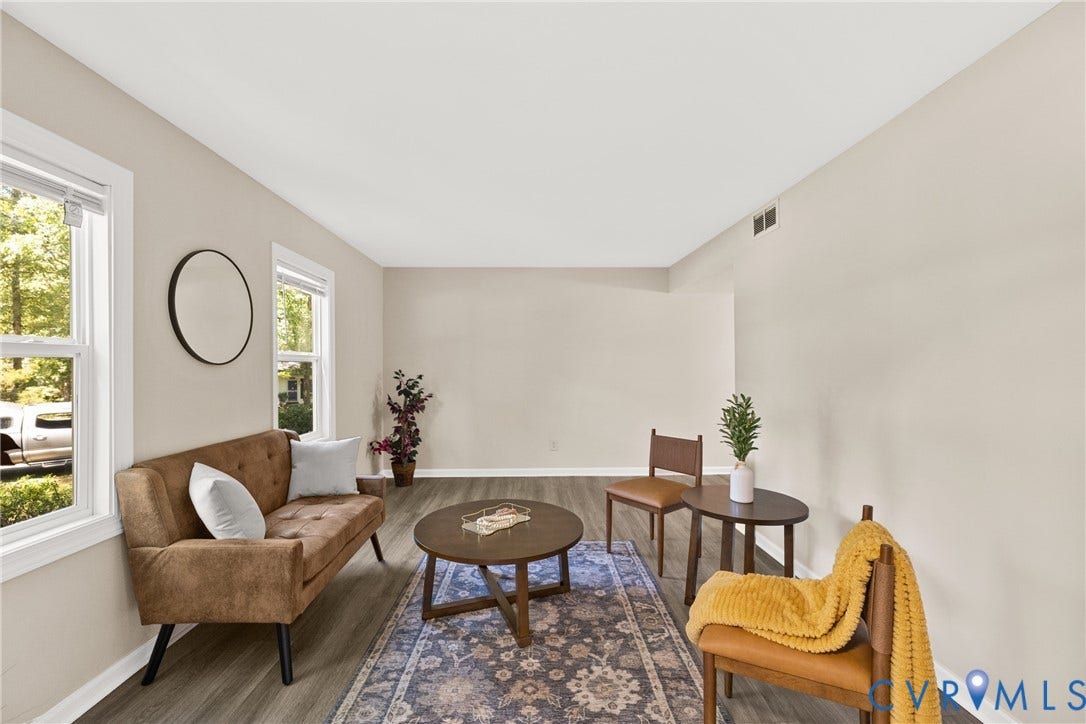 5401 Solaris Drive, Chesterfield, VA 23832 Light neutral wall paint, wood-finish flooring, white window trim, and a circular wall mirror