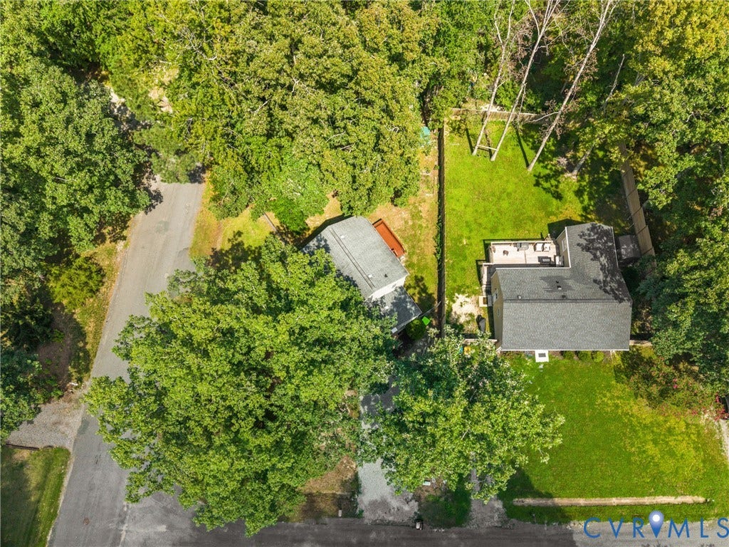 5401 Solaris Drive, Chesterfield, VA 23832 Expansive outdoor space featuring a large grassy lawn, mature trees, and a paved road