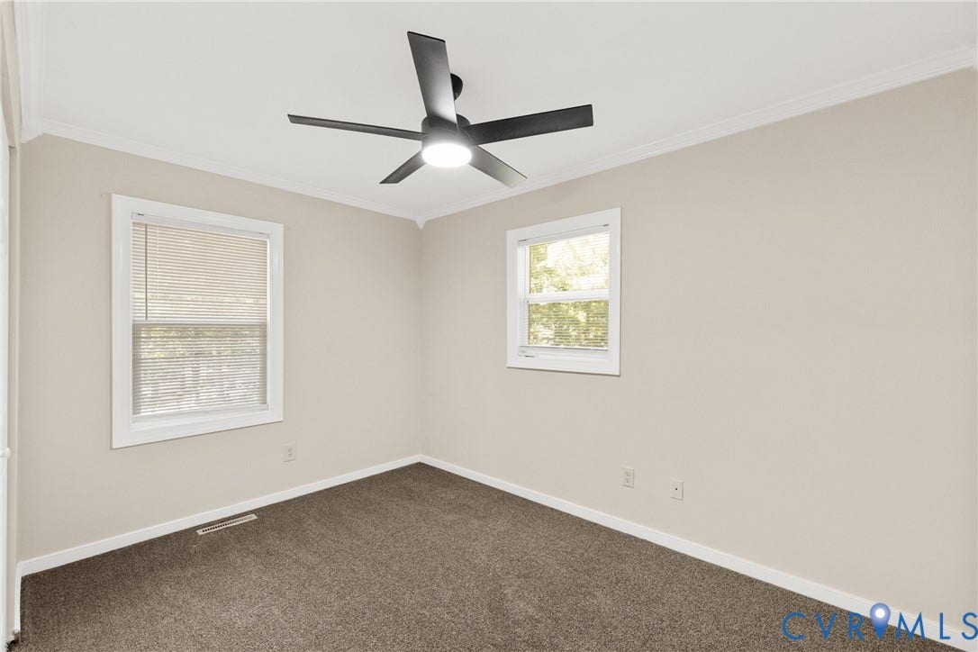 5401 Solaris Drive, Chesterfield, VA 23832 Neutral-toned walls, dark carpet flooring, ceiling fan with integrated lighting, and white window trim
