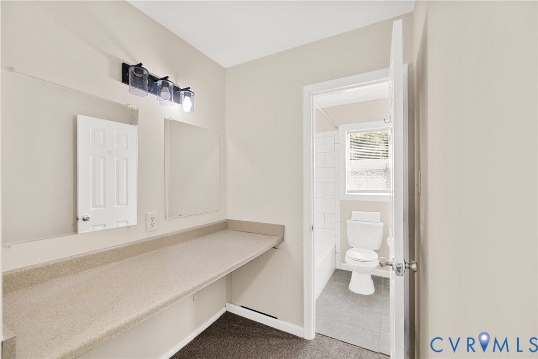 5401 Solaris Drive, Chesterfield, VA 23832 Long vanity countertop with integrated mirrors and a three-light fixture