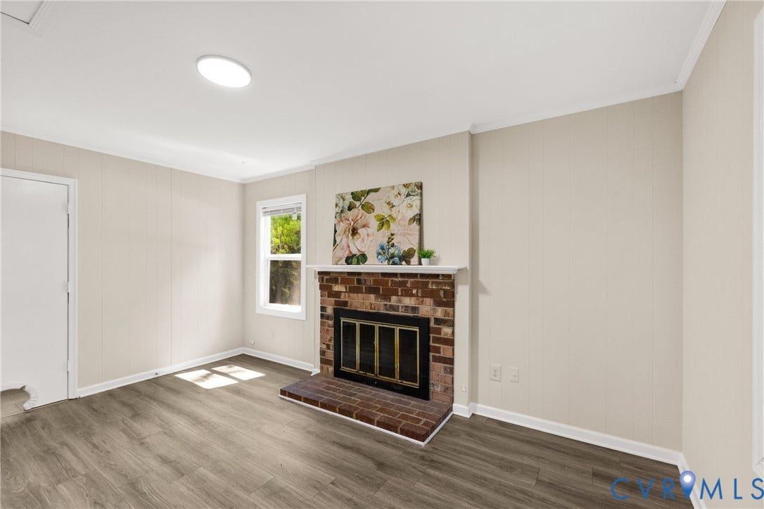 5401 Solaris Drive, Chesterfield, VA 23832 Living space featuring wood-finish flooring and a brick-surround fireplace with hearth
