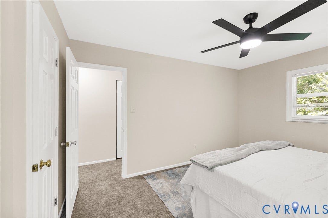 5401 Solaris Drive, Chesterfield, VA 23832 Neutral wall tones, ceiling fan with integrated lighting, window with white trim, and carpeted flooring