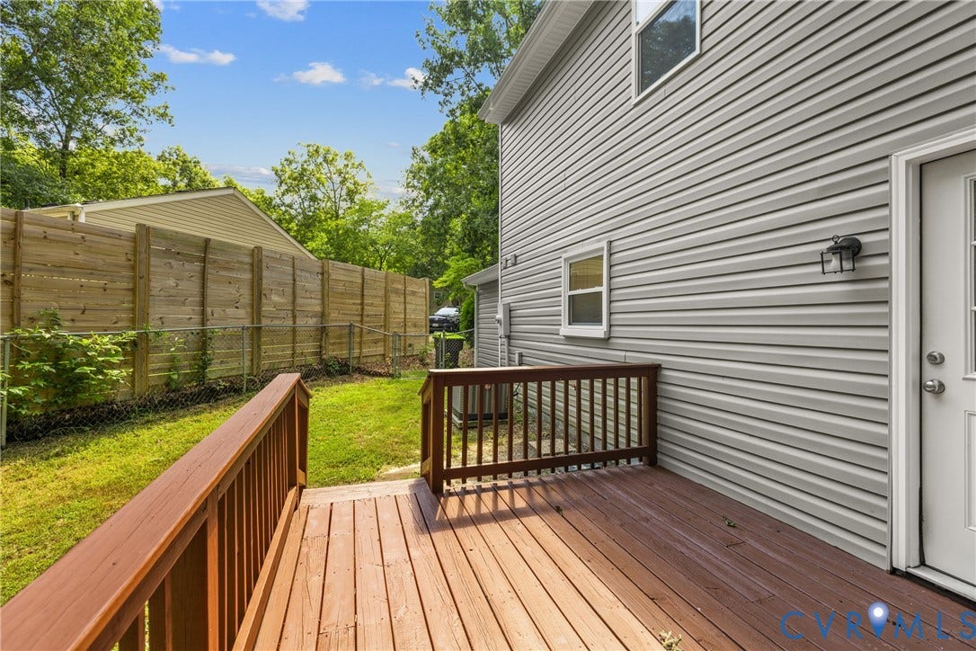 5401 Solaris Drive, Chesterfield, VA 23832 Exterior featuring light gray siding, a wood deck with railings, a white exterior door, and an exterior wall light