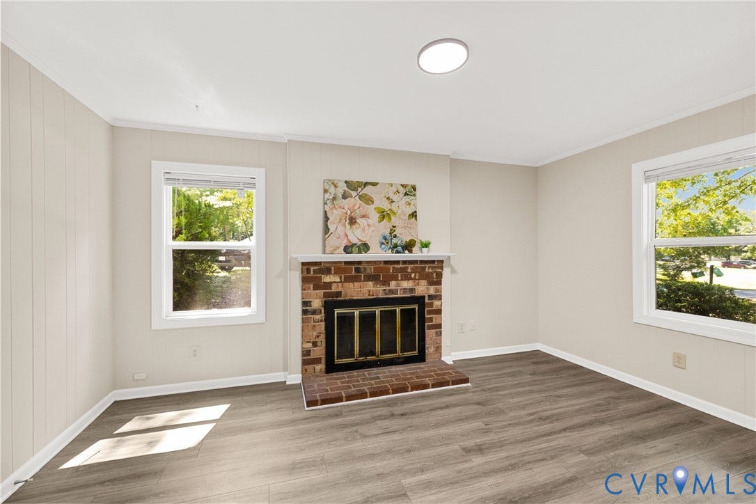 5401 Solaris Drive, Chesterfield, VA 23832 Wood-finish flooring, brick fireplace surround, multiple windows, and a flush-mount ceiling light