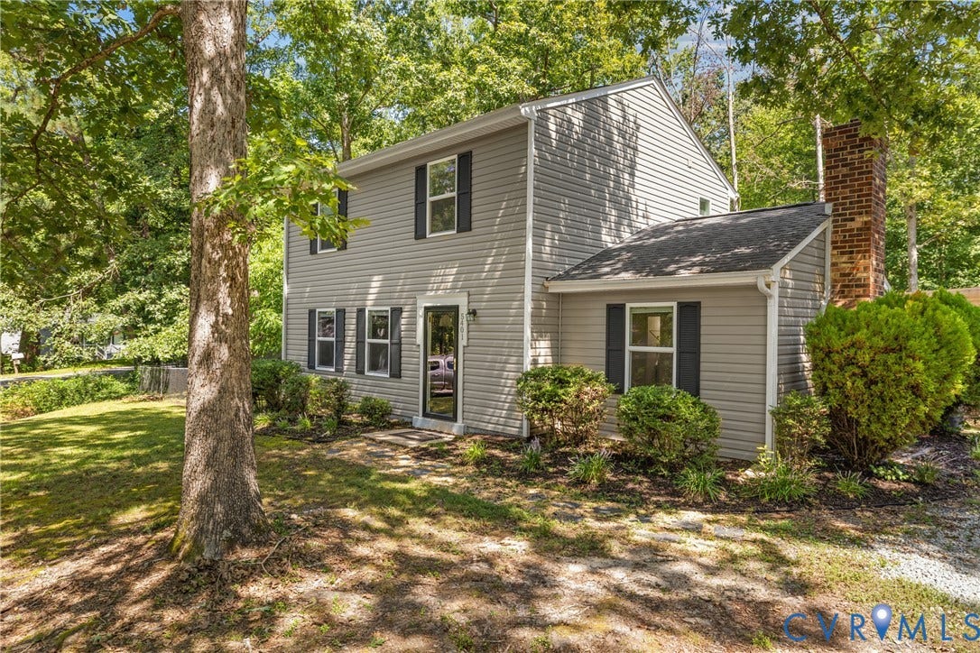 5401 Solaris Drive, Chesterfield, VA 23832 Two-story residence with siding exterior, black window shutters, and a brick chimney accent