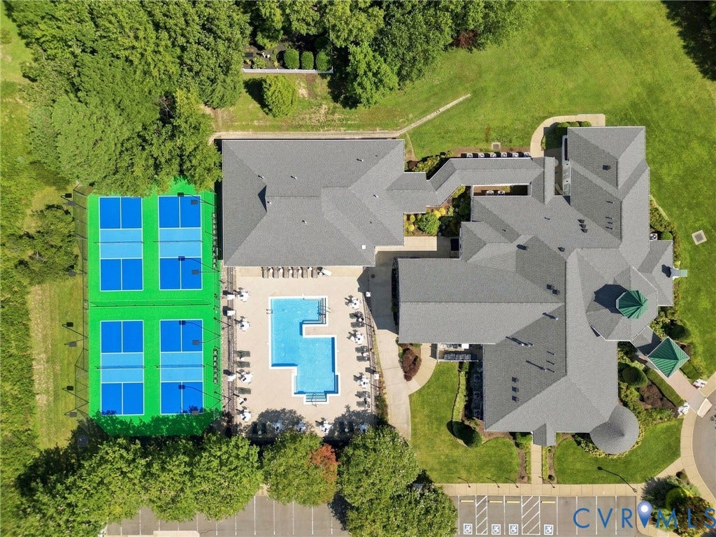 Recreational amenities featuring multiple pickleball courts, an outdoor swimming pool, and a clubhouse