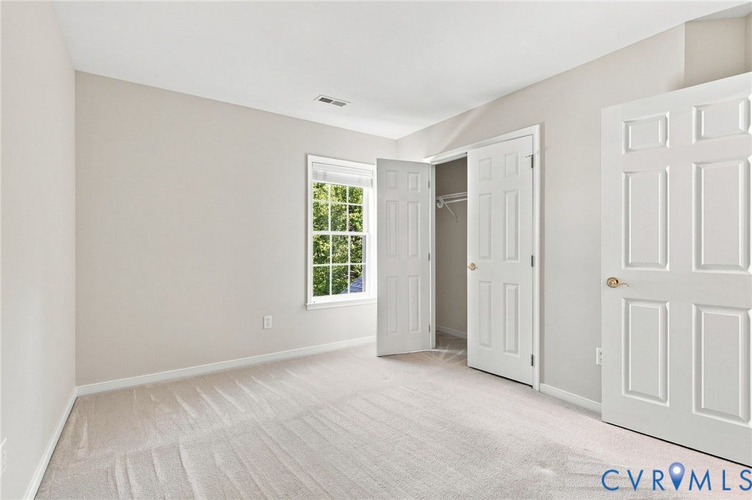 Neutral wall color, carpet flooring, dual pane window, and double closet doors